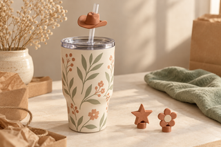 Cream botanical tumbler with a terracotta cowboy-hat straw topper and coordinating star and flower toppers