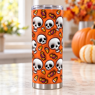 Skulls and Halloween candy on orange — one tumbler in kitchen setting