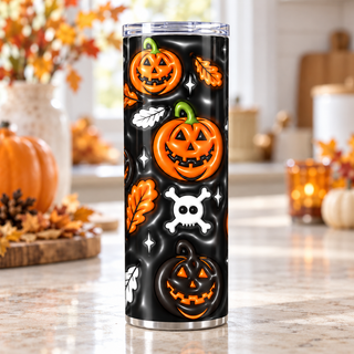 Jack-o-lanterns, skulls and autumn leaves on black — one 20 oz skinny stainless steel tumbler in a kitchen lifestyle mockup